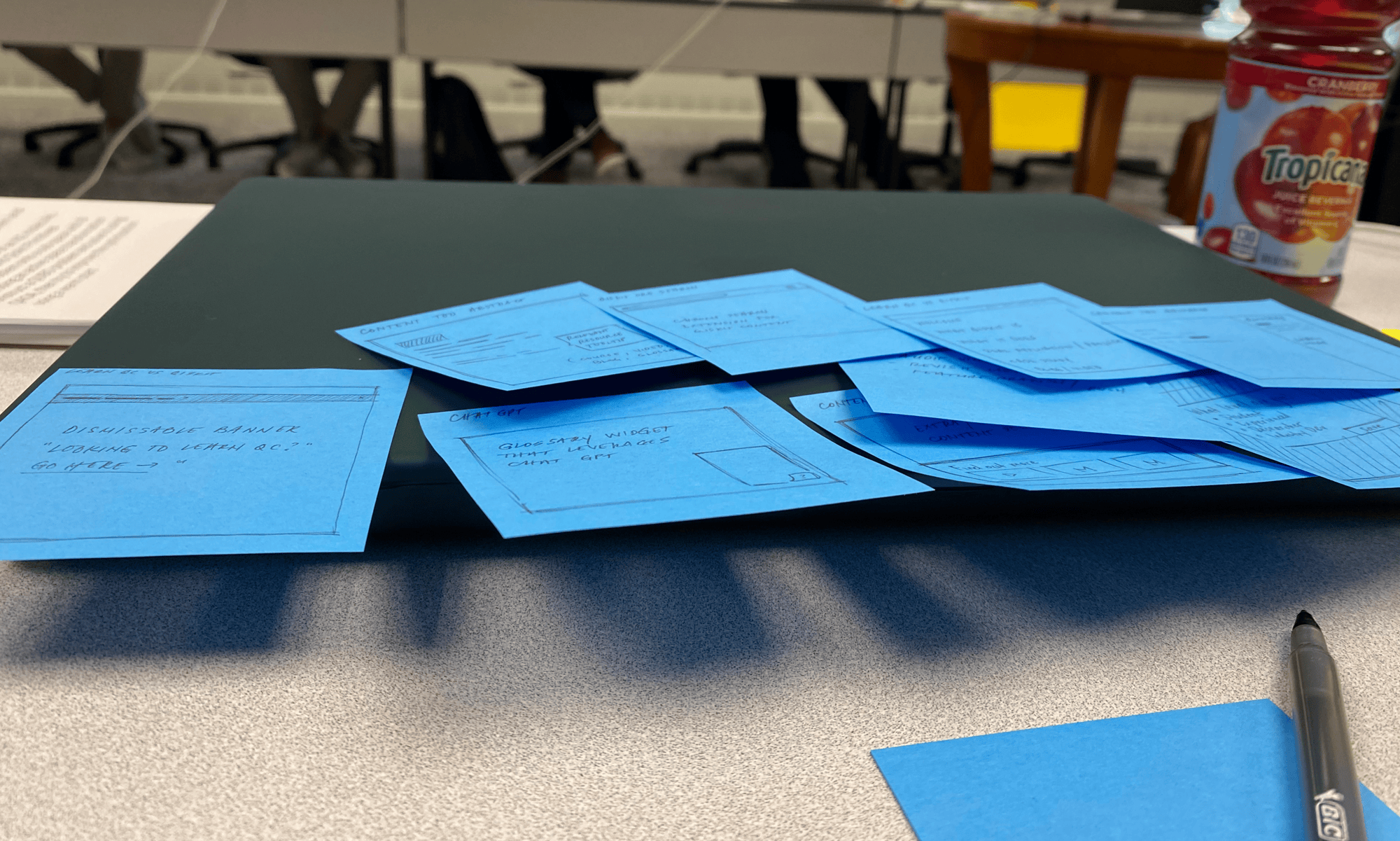 Several blue sticky notes with ideas and sketches, posted on my laptop